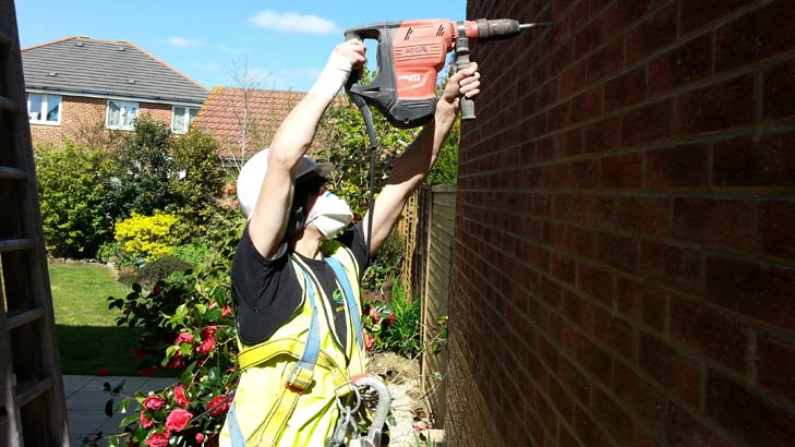 Wall having defective insulation material removed