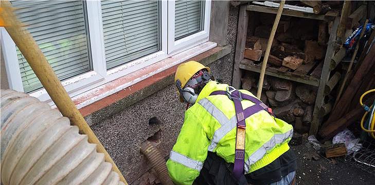 Wall having defective insulation material removed